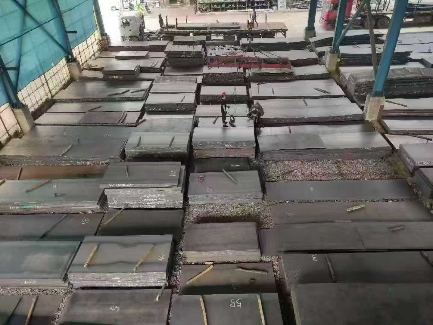 Stacks of steel plates inside the warehouse