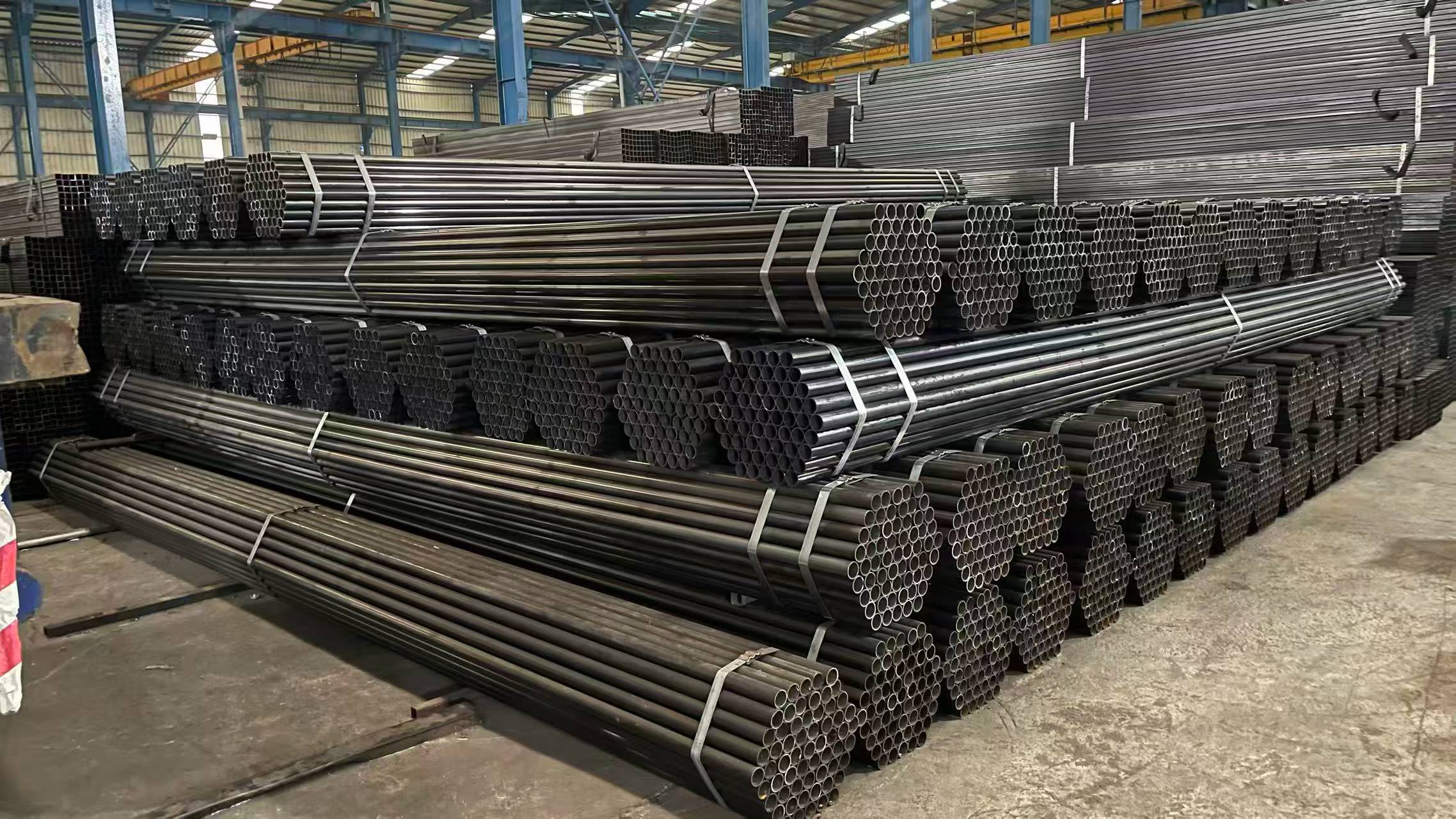 Bundles of round steel pipes in the warehouse